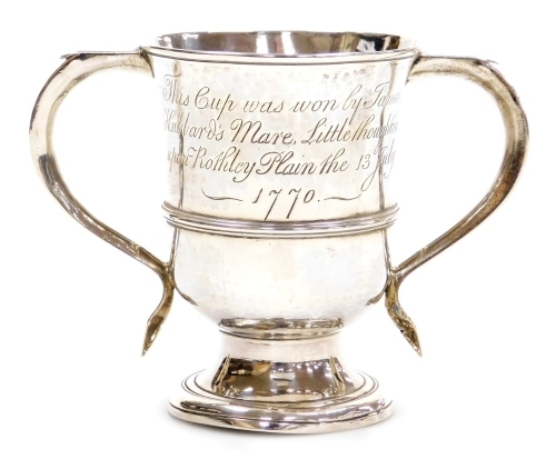 A George III silver equestrian related two handled trophy, bearing later engraving 'This Cup was won by James Hubbard's Mare, Little Houghton upon Rothley Plain, the 13th July 1770', with shaped handles on a stepped base, London 1767, 9.9oz, 12cm high.