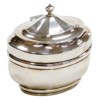 A late Victorian silver sugar box and cover, of oval shaped form, with an urn finial, the hinged lid enclosing a vacant interior, Charles Stuart Harris, London 1900, 4.64oz, 11cm high.