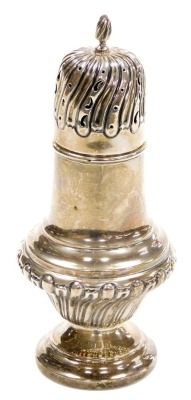 A late Victorian silver sugar sifter, of baluster semi fluted form, with a flame shaped final above a pierced repousse decorated lid, William Davenport Birmingham 1899, 5.47oz, 19cm high.