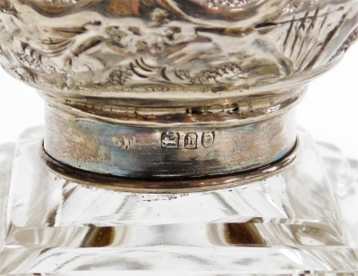 An Edward VII cut glass and silver mounted scent bottle, the lid embossed with flowers and scrolls, the bottle of rectangular form with stopper, on a white metal pierced base decorated with scrolls and flowers, London 1903, 14cm high. - 3