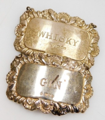 A group of small silver, comprising four decanter labels for sherry and port, Sheffield 1976, and gin and whisky, London 1972 and Sheffield 1979 and three napkin rings, weighable silver 4.06oz. - 4