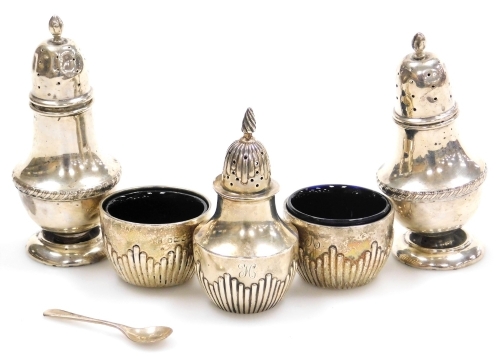 A group of small silver, comprising a pair of Victorian pepper pots of baluster form, Birmingham 1850, a further Victorian pepper pot, a salt spoon and two open salts, with blue glass liners, weighable silver 5.94oz.