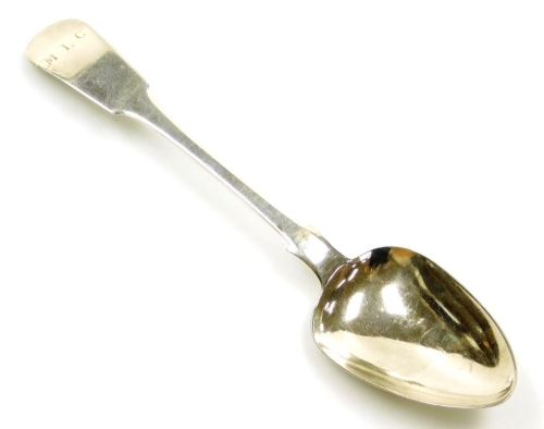 A late 18thC silver Fiddle pattern serving spoon, bearing initials, by repute Jersey silver circa 1790, hallmarks rubbed, 1.5oz, 22cm long.