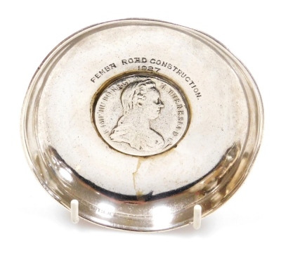 A George V silver dish, bearing presentation inscription 'Pemba Road Construction 1927,' and inset with a 1780 Maria Theresa thaler, Birmingham 1927, 2.64oz all in, 11cm diameter.