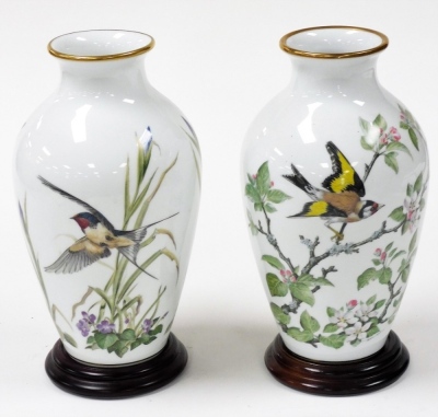 A pair of Franklin Mint porcelain bird vases, limited edition, circa 1980, with stands, comprising The Meadowland Bird vase, and The Woodland Bird vase, vases 29.5cm high. - 2