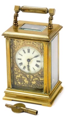 A late 19thC brass cased carriage clock, the circular enamel dial bearing Roman numerals, against a plate worked in relief with flowers and scrolling leaves, single barrel movement, the case of conventional form, with beaded trim, with key, 11cm high.