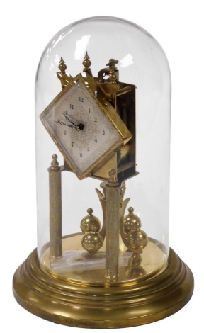 A Continental brass four hundred day anniversary clock, with a rhomboid silvered dial with engraved decoration, chapter ring bearing Arabic numerals, on a brass base with a glass dome, with key, dome 30.5cm high.