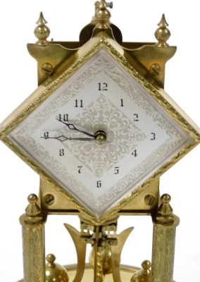 A Continental brass four hundred day anniversary clock, with a rhomboid silvered dial with engraved decoration, chapter ring bearing Arabic numerals, on a brass base with a glass dome, with key, dome 30.5cm high. - 2