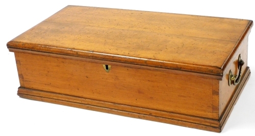 A Victorian oak writing box, of rectangular section, the hinged lid opening to reveal a compartmented tray and vacant interior, with twin brass carrying handles, 14cm high, 47cm wide, 25cm deep.