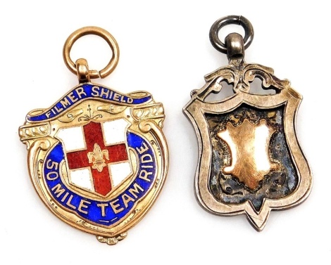 A 9ct gold and enamel shield pendant ''Film Shield 50 Mile Team Ride'', 6.2g, together with a Dunholme and Welton United Football Club silver medallion, named for T Makins, NLVL, 2nd Div, 1924/25. (2)