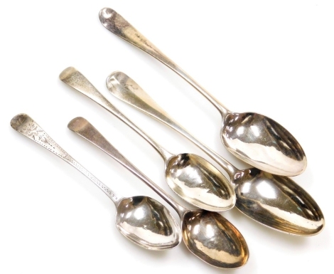 A George III silver rat tail pattern serving spoon, initialled to handle and below bowl verso, a further Georgian rat tail pattern serving spoon, hallmarks rubbed, and three Georgian dessert spoons, one bright cut engraved, 6.03oz.