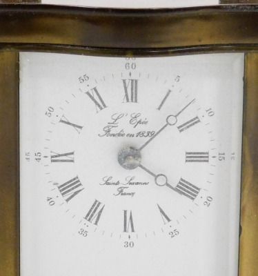 A L'Epee brass cased carriage clock, the dial inscribed L'Epee Fondee 1839, Saint Suxanne France, bearing Roman and Arabic numerals, single barrel movement, in shaped case engraved Corah Limited 1979 B. Wilcox, with carrying handle, 11cm high. - 2