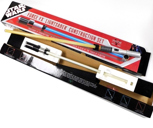 A Star Wars Yoda Force FX light sabre, boxed, and a Star Wars Master Replicas Force FX light sabre construction set, boxed.