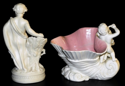 A late 19thC parian spill vase, modelled as a boy wearing a toga, leaning against a tree stump, raised on an oval base, 23cm high, together with an Italian shell form pottery vase, modelled with putti, 21cm high. (2) (AF) - 2