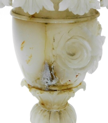 An Italian alabaster table lamp, of twin handled baluster form, carved with leaves and roses, 35cm high, two further alabaster table lamps and an onyx table lamp. (4) - 3