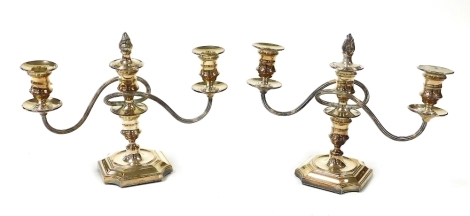 A pair of late 19thC Walker & Hall silver plated twin branch candelabra, with flame finial top snuffers, 31cm wide.