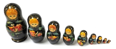 A Russian Babushuko doll, nine graduated with painted decoration, largest 24cm high.