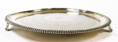 A Victorian Elkington & Company silver plated salver, with a gadrooned rim, engraved centrally with bands of acanthus and holly leaves, shamrocks, etc., centrally monogram engraved, raised on three scroll feet, impressed marks, 36cm wide. - 4