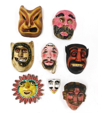 A group of Haitian wooden masks, together with a Mexican clay mask. (8)