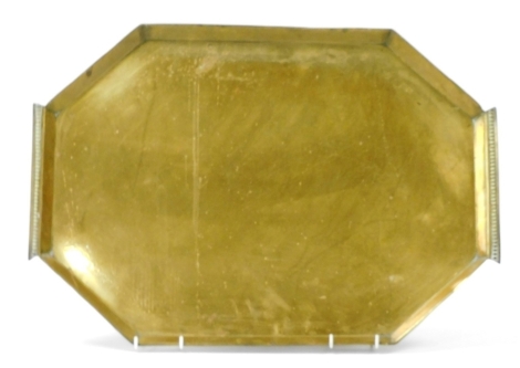 An Arts and Crafts brass twin handled octagonal tray, with engraved foliate decoration, 60.5cm wide.