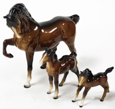 A Beswick pottery model of a seated cat, number 1867, brown glazed horse, right leg up, two foals, a character jug modelled as Pickwick, and another as Micawber. (6) - 2