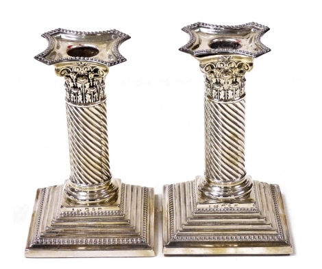 A pair of Victorian silver candlesticks, of Corinthian column form on a stepped, loaded base, Solomon Lyon, Birmingham 1876, 14.5cm high.