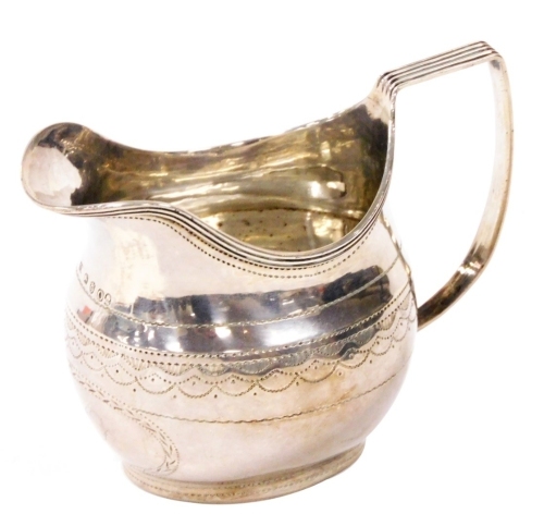 A George III silver cream jug, of helmet shaped form, with angular handle and bright cut decoration, monogrammed to body, John Merry, London 1789, 3.31oz, 8cm high.