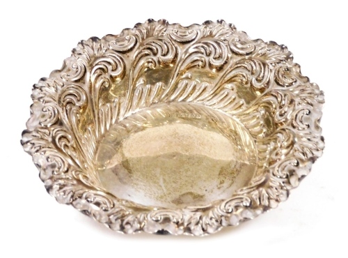 A Victorian silver bonbon or sweet meat dish, embossed with foliate scrolls, Sheffield 1896, 1.64oz, 11.5cm diameter.