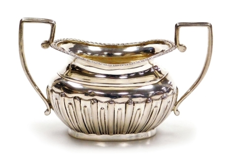 A Victorian silver two handled semi fluted sugar bowl, with a gadrooned rim, George Nathan and Ridley Hayes, Chester 1900, 3.79oz, 8cm high.