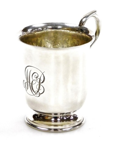 A George V silver Christening cup, of plain form with engraved monogram, on a circular foot, GF Westwood and Sons, Birmingham 1924, 3.10oz, 8cm high.