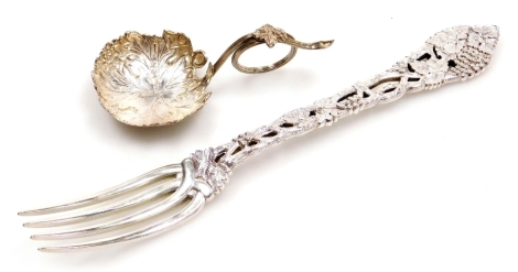 An Edward VII silver decorative fork, with elaborate cast and pierced vine decorated handle, Dobson & Sons (Thomas William Dobson), London 1903, and a Victorian silver caddy spoon, with a shaped vine leaf bowl and twisted vine stem handle, George Unite, B