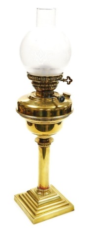 A Veritas brass oil lamp, with a clear and etched chimney shade, 63cm high.