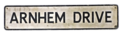 A mid century street sign, for Arnhem Drive, black on a white background, 105cm wide.