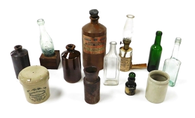 Victorian glass bottles, storage jars including Stephens blue black writing fluid and Tuxford & Tebbutt Limited Stilton cheese, and a Dr Ely Parson's Famous Miracle oil lamp. (a quantity)