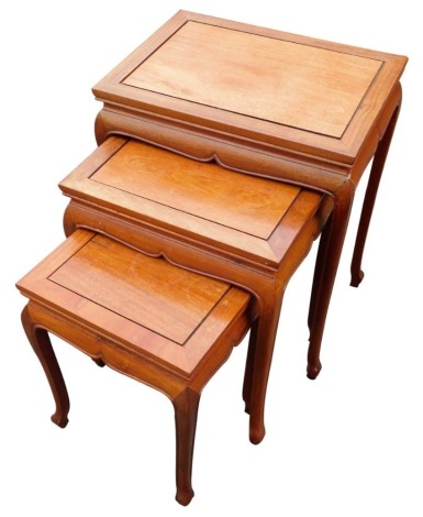 A nest of three Oriental hardwood tables, the largest 64cm high.