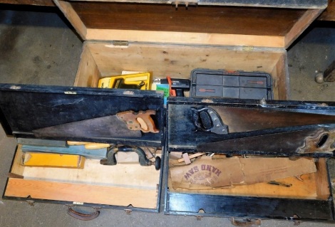 A black stained pine tool chest, containing assorted electrical and other carpentry tools, 44cm high, 101cm wide, 36cm deep, and two further toolboxes, containing assorted carpentry tools, each 79cm wide, 42cm deep.