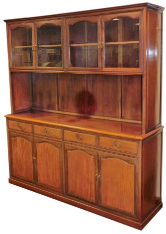 A Chinese elm display cabinet, the top with four glazed doors enclosing a single shelf, above a recess with four drawers and four cupboards to base with brass tear drop handles, 197cm high, 178cm wide, 49cm deep.