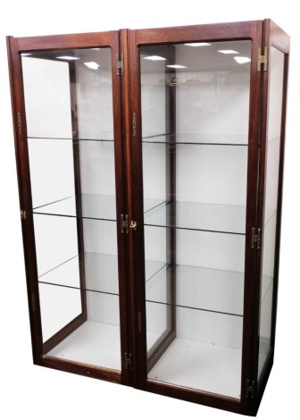 A pair of early 20thC oak framed display cabinets, with glass front and sides, the hinged door enclosing three glass shelves, one lacking brass latch, 172cm high, 62cm wide, 57cm deep.