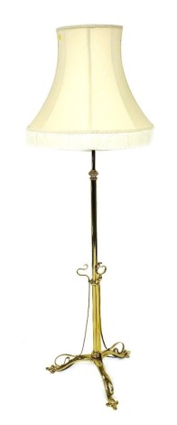 A Victorian Arts and Crafts brass standard lamp, with shade, 175cm high.