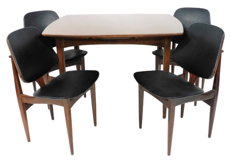 A mid century Elliotts of Newbury draw leaf dining table, raised on chamfered legs, 73cm high, 108cm wide, 889cm deep, together with four single dining chairs with black leatherette seats.