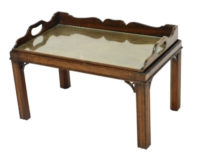 A Chippendale style tray top occasional table, raised on channelled square legs, 42cm high, 67cm wide, 41cm deep.