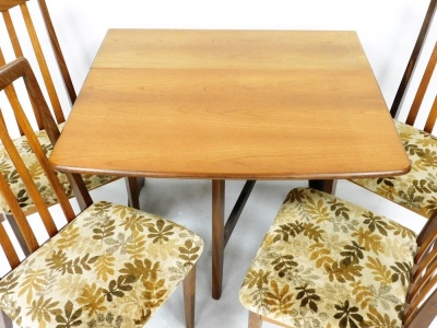 A 1960's G-Plan teak drop leaf dining table, raised on trestle end supports united by a straight stretcher, 73cm high, 30cm wide, 174cm extended, 90cm deep, together with four single dining chairs. The upholstery in this lot does not comply with the 1988 - 2