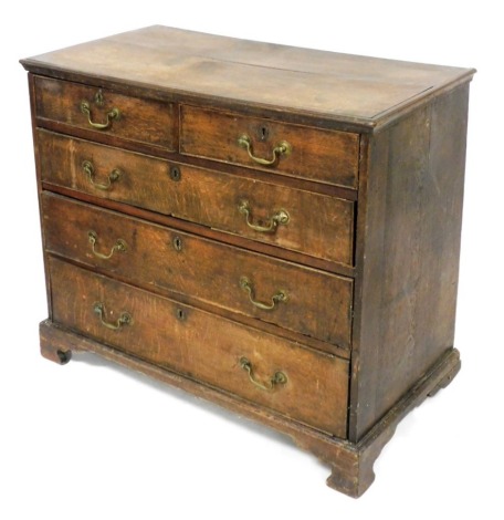 A George III oak chest of two short over three long graduated drawers, raised on bracket feet, 82cm high, 97cm wide, 50.5cm deep.