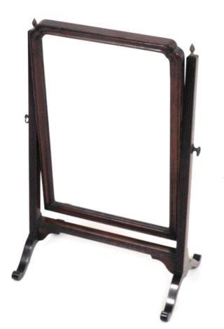 A 19thC mahogany swing frame dressing table mirror, the rectangular plate with a moulded border, on reeded supports with splayed legs, 40cm wide.