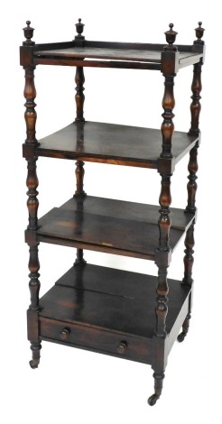 A Victorian rosewood four tier whatnot, raised on baluster turned supports, the bottom tier with a frieze drawer, raised on turned legs, brass capped on castors, 126cm high, 51cm wide, 44cm deep. (AF)