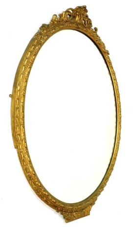 A Victorian gilt gesso oval wall mirror, with a foliate scroll surmount and egg and berry moulding, 123cm high, 94cm wide.