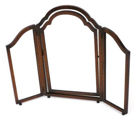 An early 20thC Georgian style walnut triptych dressing table mirror, raised on bun feet, 74cm high, 88cm wide.