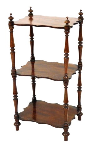 A Victorian mahogany three tier whatnot, with serpentine shaped shelves, raised on turned columns, 79cm high, 38cm wide, 31cm deep.