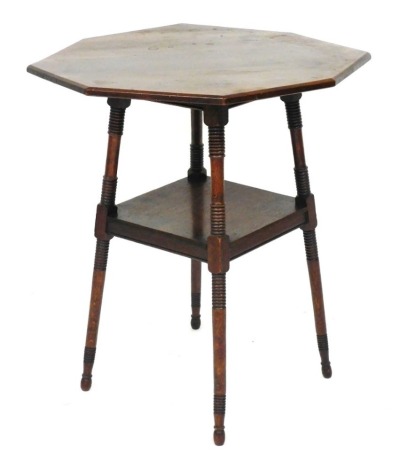 A Victorian oak octagonal occasional table, raised on ring turned supports united by a square under tier, 70cm high, 59cm wide.