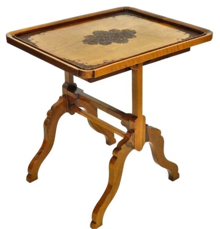 An Indian hardwood Padouk occasional table, the rectangular galleried tilt top with fine leaf and floral carving of medallion and spandrels, on end supports with shaped legs, the top 49cm x 61cm.